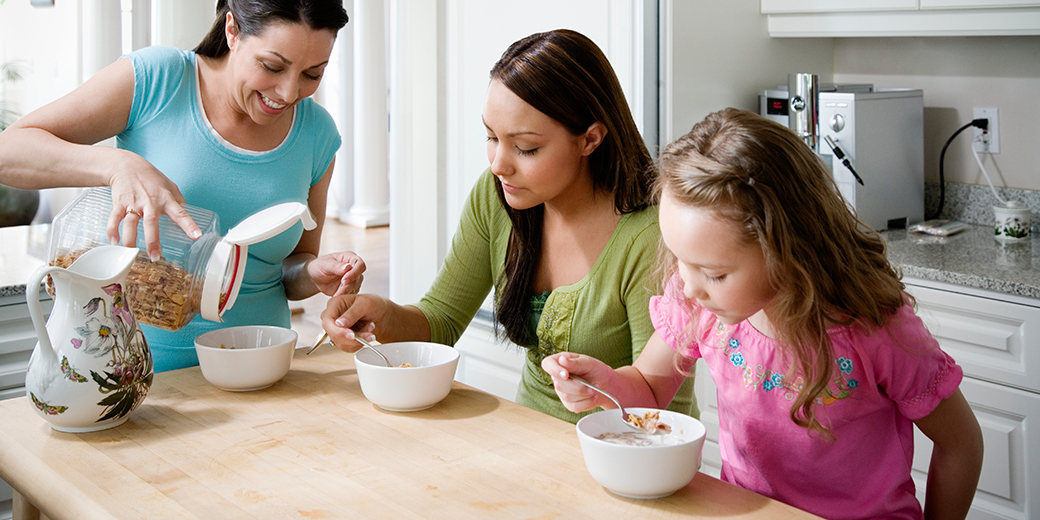 Family having cereal for breakfast at kitchen table