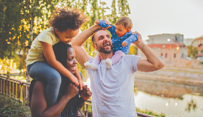 family holding their children