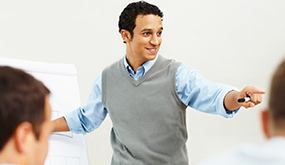 a man enthusiastically presenting using a whiteboard