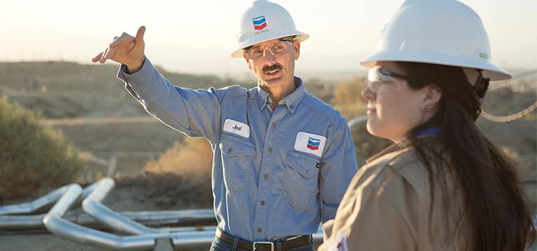 man pointing wearing a Chevron hard hat and shirt
