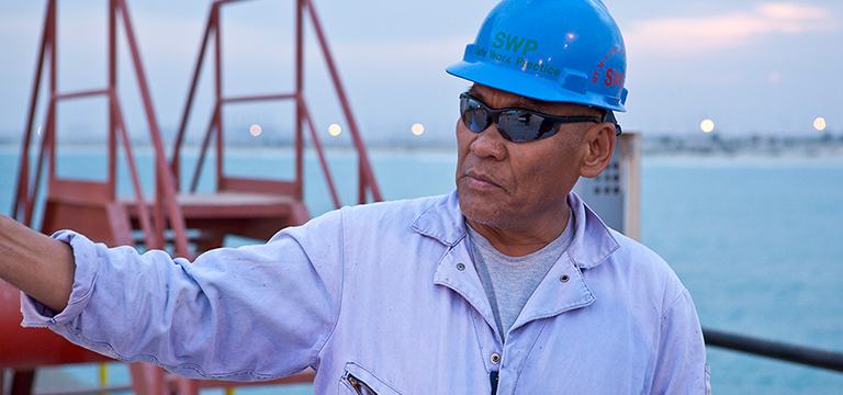 man wearing blue hard hat and sunglasses