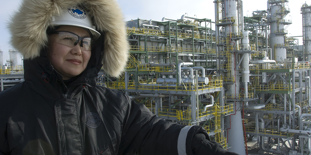 woman in hardhat and winter coat on platform