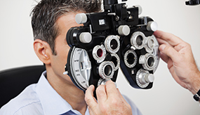 a man having his vision examined using a lensometer