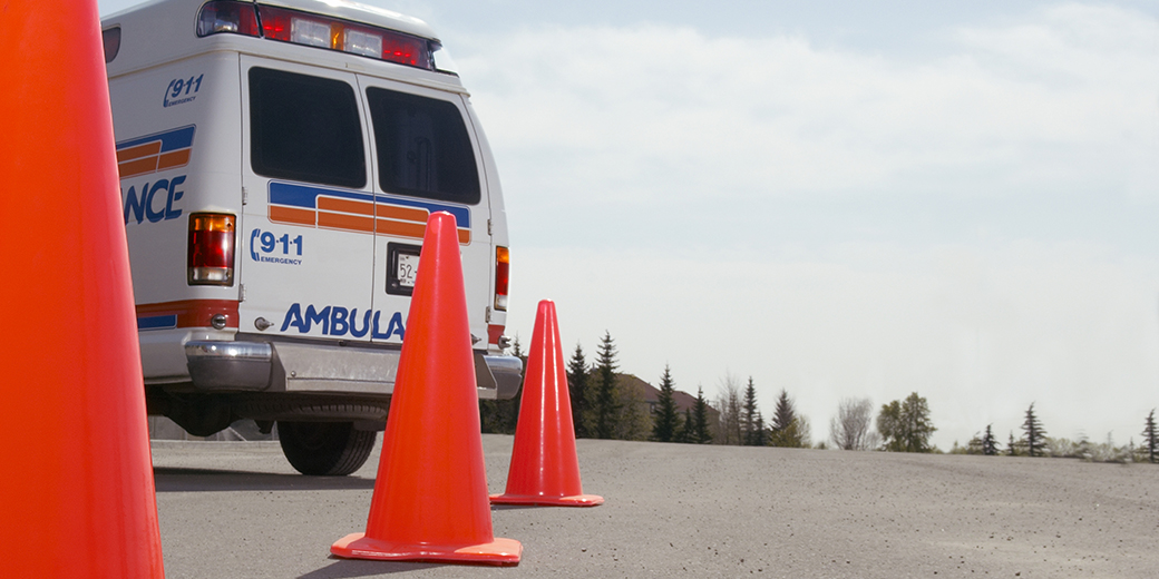 back of an ambulance, fronted by traffic cones