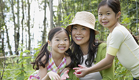 a woman and two girls outdoors