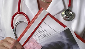 closeup of stethoscope hanging from doctor's shoulder