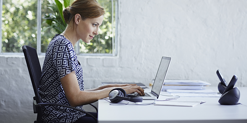 a woman working from home at a laptop