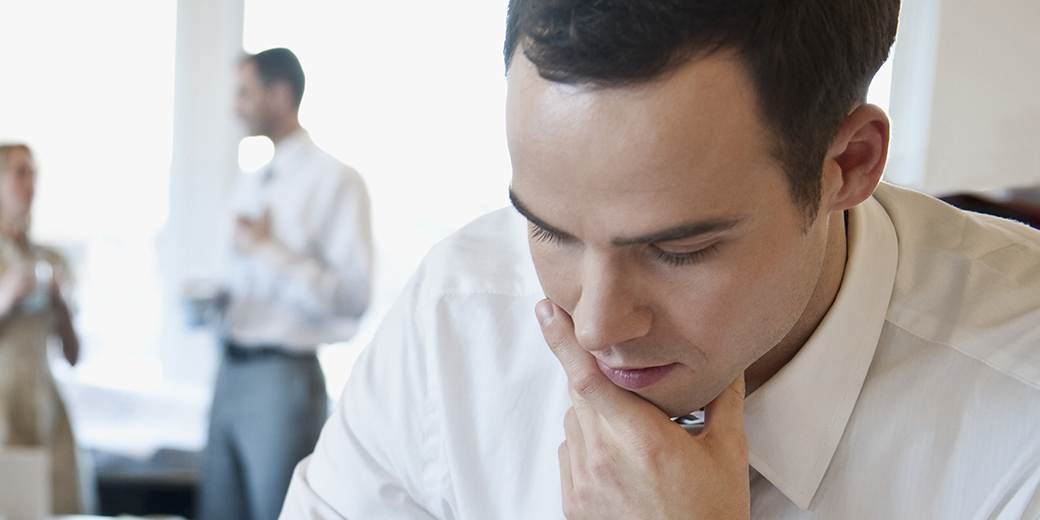 a man immersed in thought, with hand on his chin