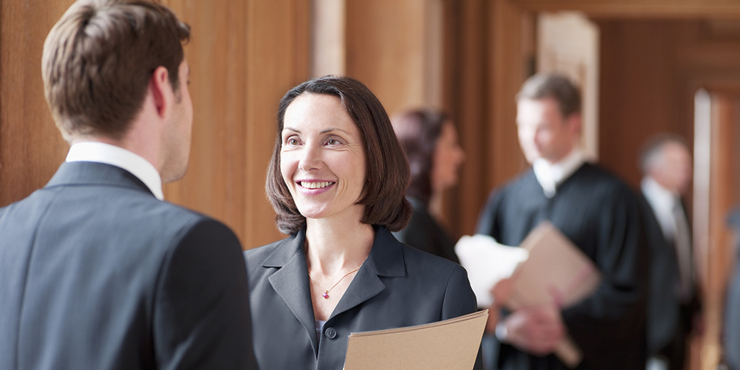 a woman holding files in a court of law