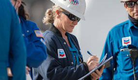 a Chevron worker on site using a clipboard