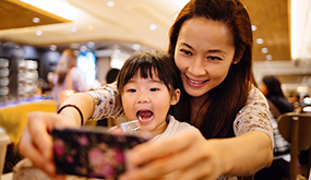 mom taking selfie with daughter