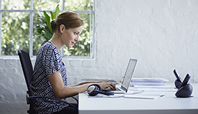 a woman working at laptop from home