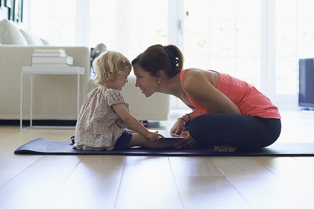 woman playing with child on floor