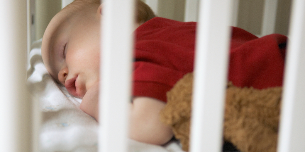 closeup of infant sleeping in crib